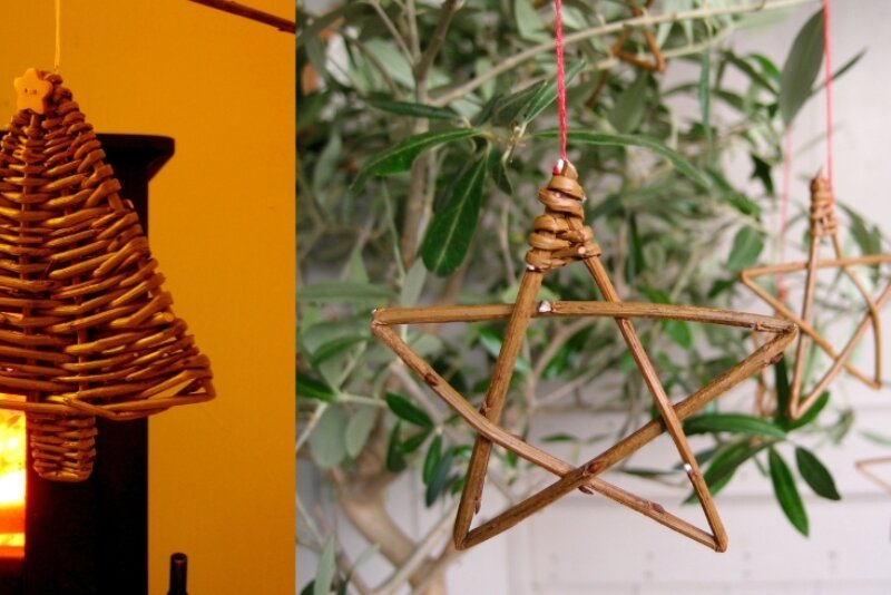 bell shaped willow Christmas decoration on the left with a star shaped Christmas decoration on the right
