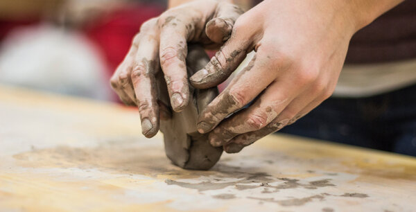 A photo of a person making clay.