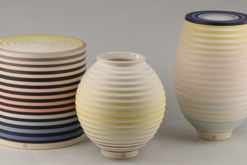 three pots made of clay, they have Op Art style illusion designs on the
